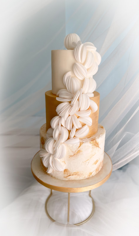 modern white and gold 3 tier wedding cake with concrete effect tectured bottom tier and wafer paper decoration