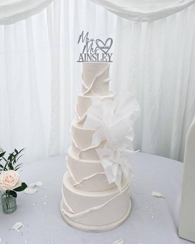 5 tier white modern wedding cake with rice paper sails 