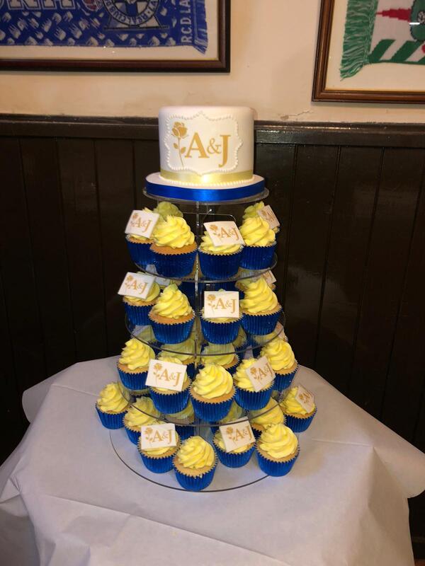 blue yellow and wedding cake and cupcake tower with groom and groom initials